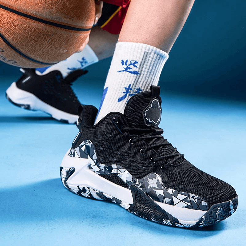 Man wearing breathable mesh sports shoes with cushioning, featuring black and white geometric patterns, holding a basketball on blue background.